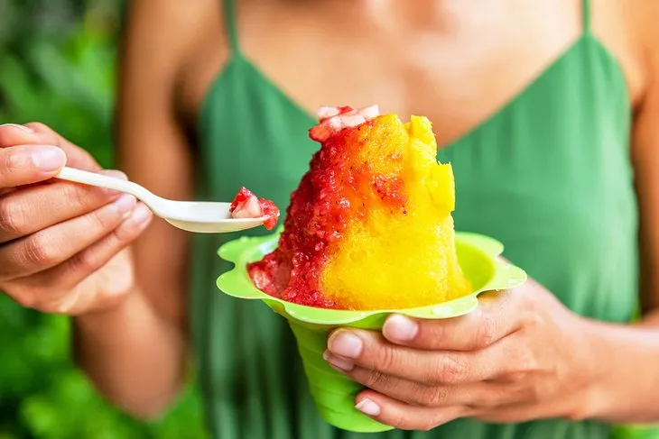 Enjoying colorful shave ice, a refreshing treat while sightseeing Honolulu.