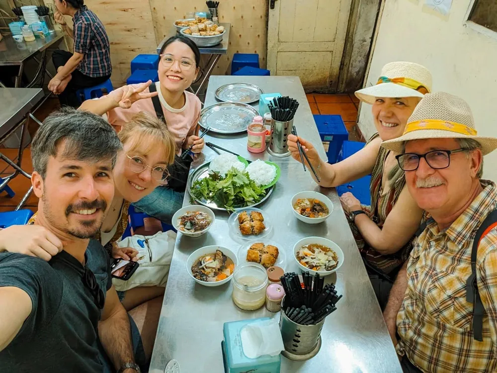 Enjoying delicious street food in Hanoi, a must-do culinary experience in Vietnam
