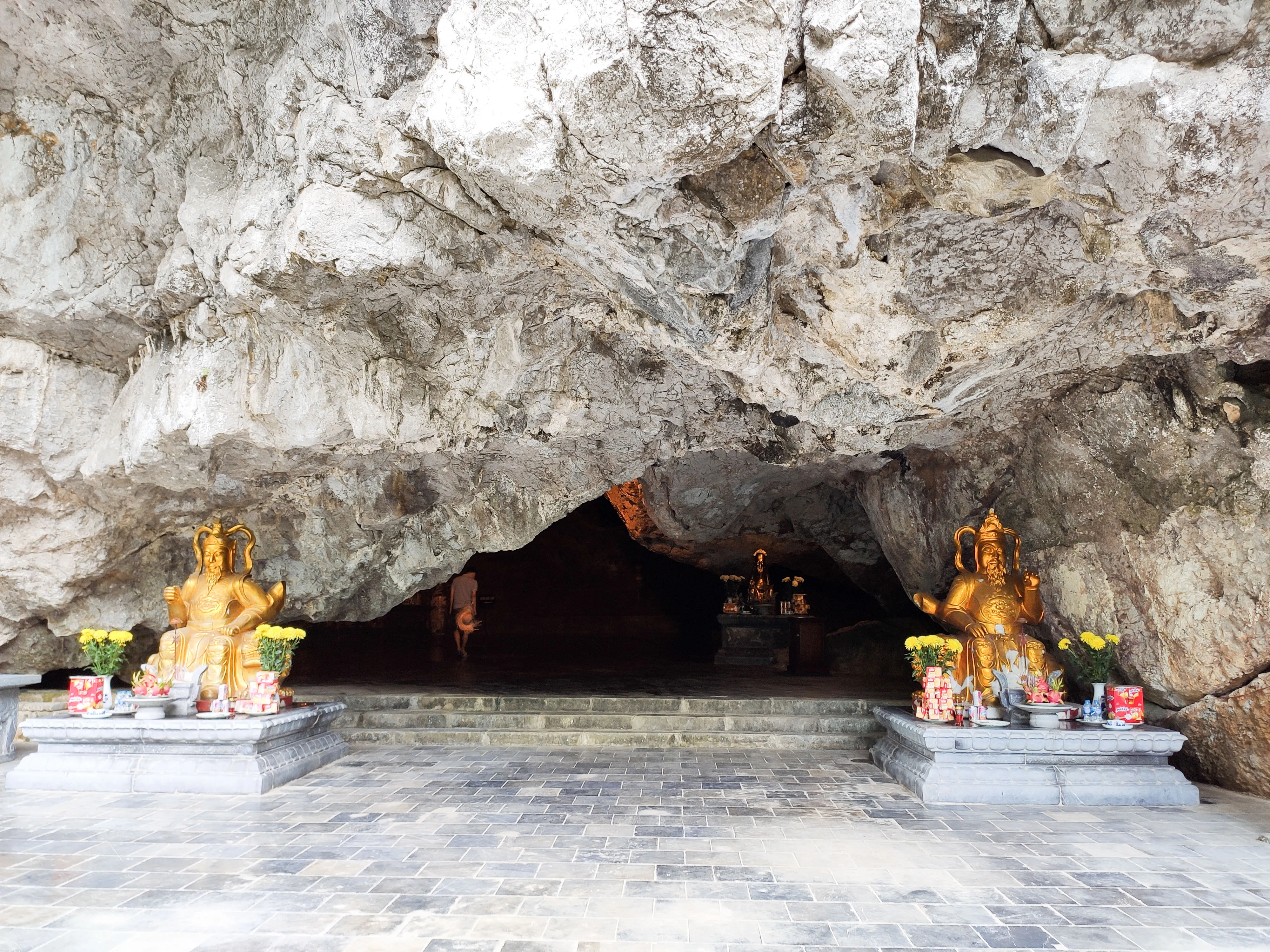 Entrance to Am Tien Cave nestled in the side of a karst mountain