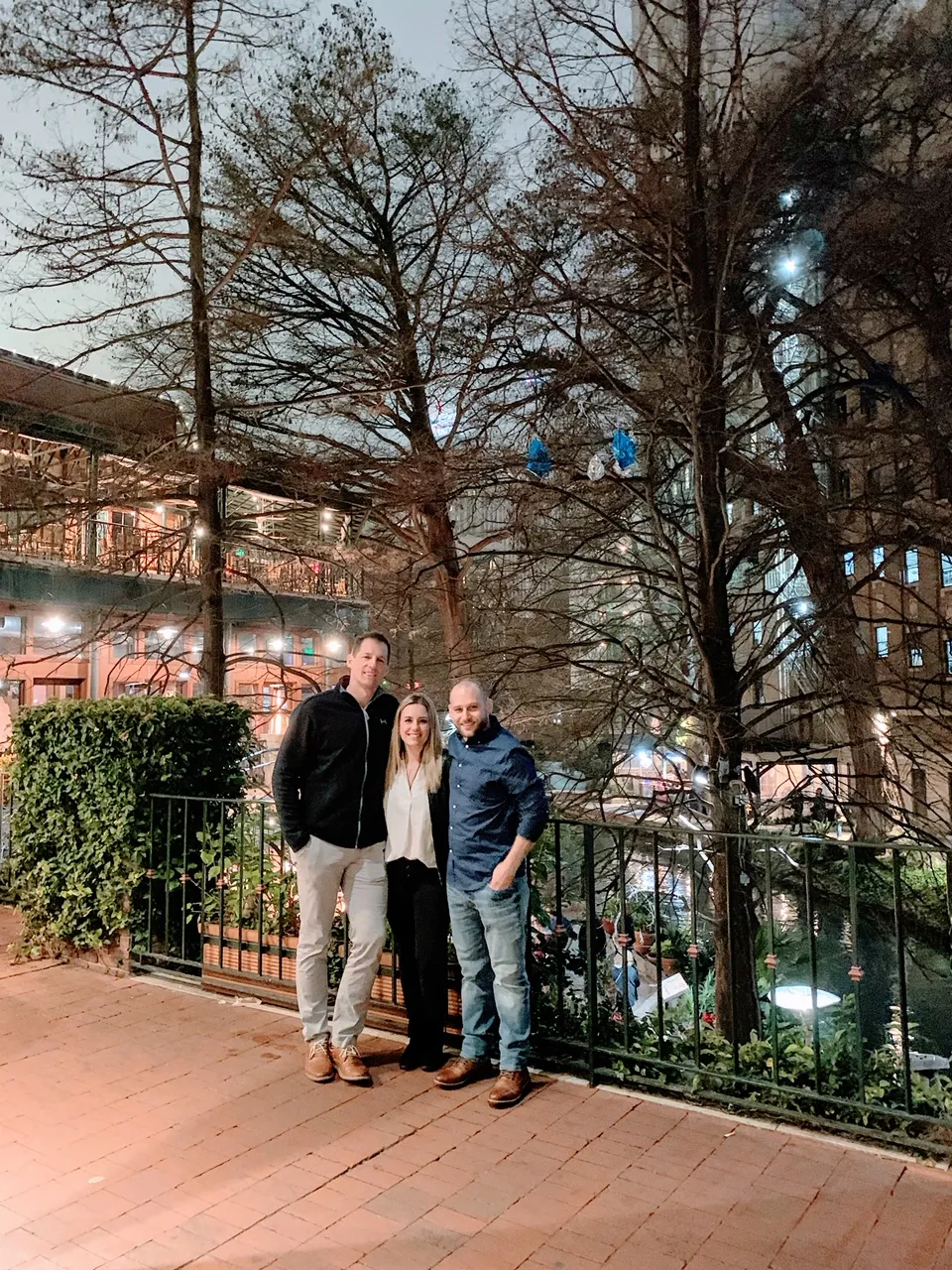 Evening view of the San Antonio River Walk illuminated, showcasing urban beauty when traveling to Texas