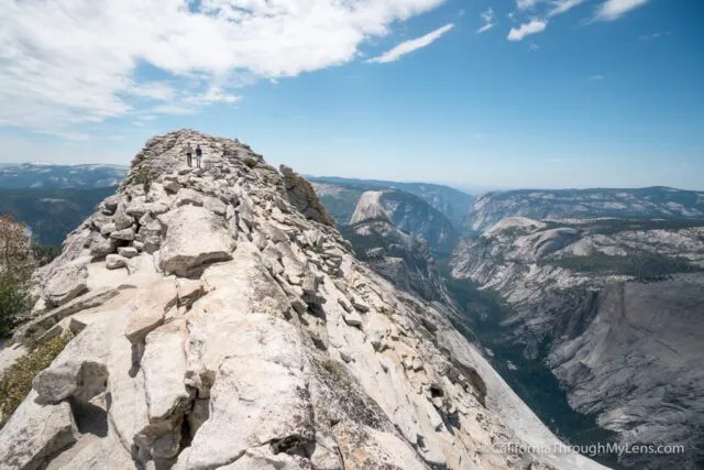 Expansive panoramic view from the summit of Clouds Rest in Yosemite National Park overlooking Half Dome and the valley