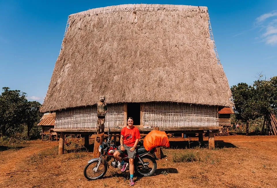 Exploring off the beaten track in a rural Vietnamese village on a motorbike, highlighting adventurous travel.