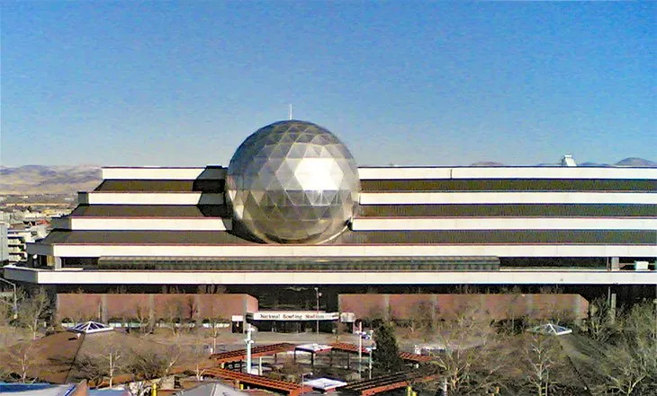 Exterior shot of the National Bowling Stadium in Reno, featuring the giant bowling ball sculpture.