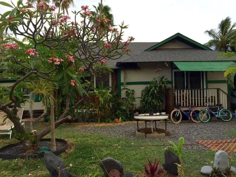 Exterior view of Hakuna Matata Hostel in Maui, showing an outdoor seating area.