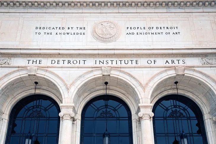 Exterior view of the Detroit Institute of Arts building with sculptures in front