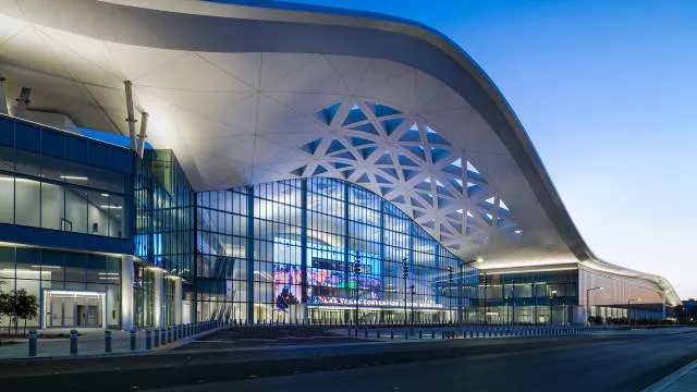 Exterior view of the modern LVCC West Hall Entrance with palm trees and clear sky