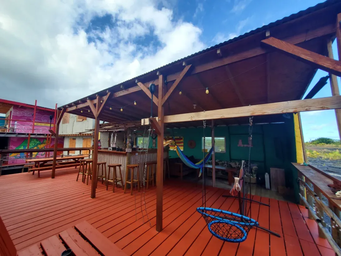 Exterior view of the Open Gate Hostel in Pahoa, Hawaii, showing its unique artistic style and setting.