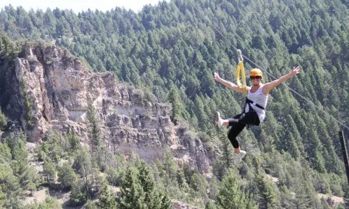 Family enjoying a whitewater rafting trip on a Montana vacation package.