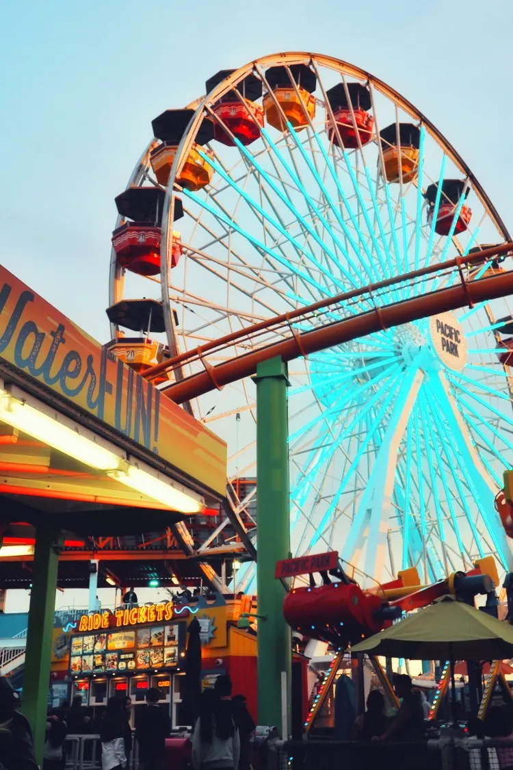 Ferris wheel and roller coaster on the Santa Monica Pier at sunset