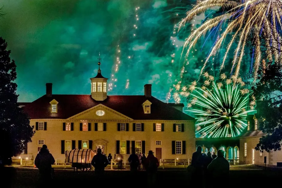Fireworks bursting over the Potomac River during the Christmas Illuminations event at Mount Vernon