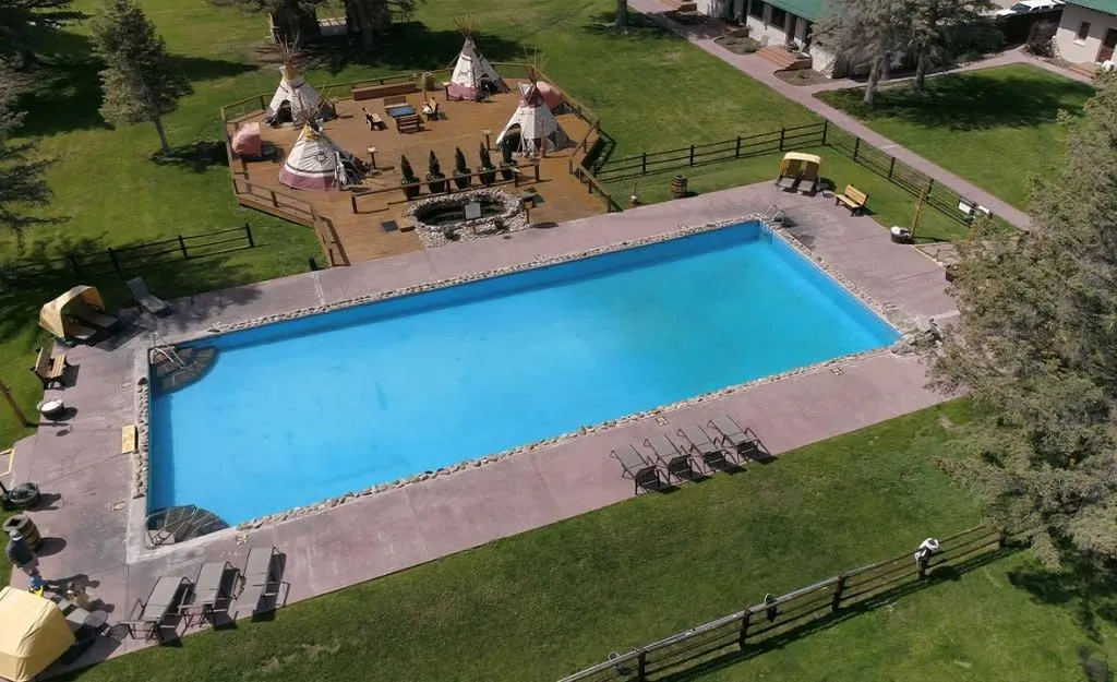 Four teepees covering hot pools and a mineral hot spring pool at Saratoga Hot Springs