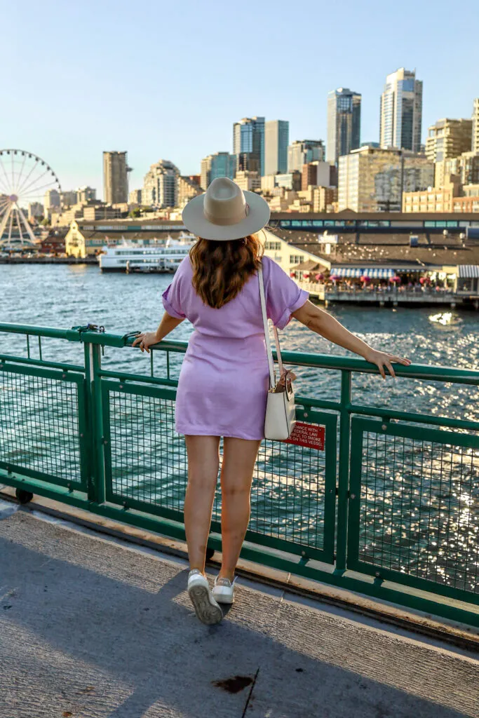 girl on the bainbridge island ferry with seattle skyline in the background