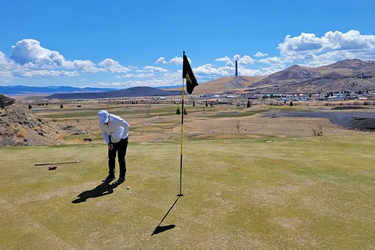 Golfing at Old Works with the smelter stack in the background