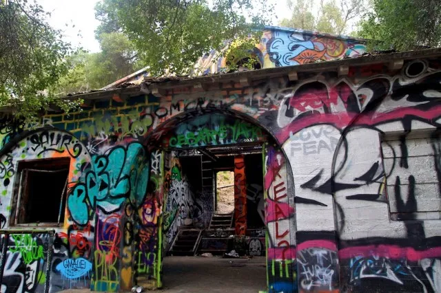 Graffiti-covered concrete structure in a wooded area (Murphy's Ranch)