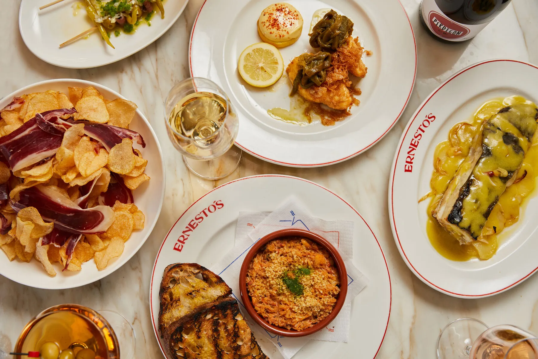 Grilled seafood and vegetables from Ernesto's, emphasizing the smoky flavors achieved by cooking over a fire.