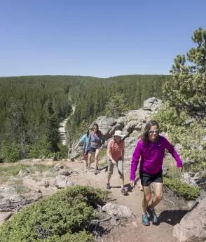 Group of friends hiking on a trail with mountain views near Casper Wy