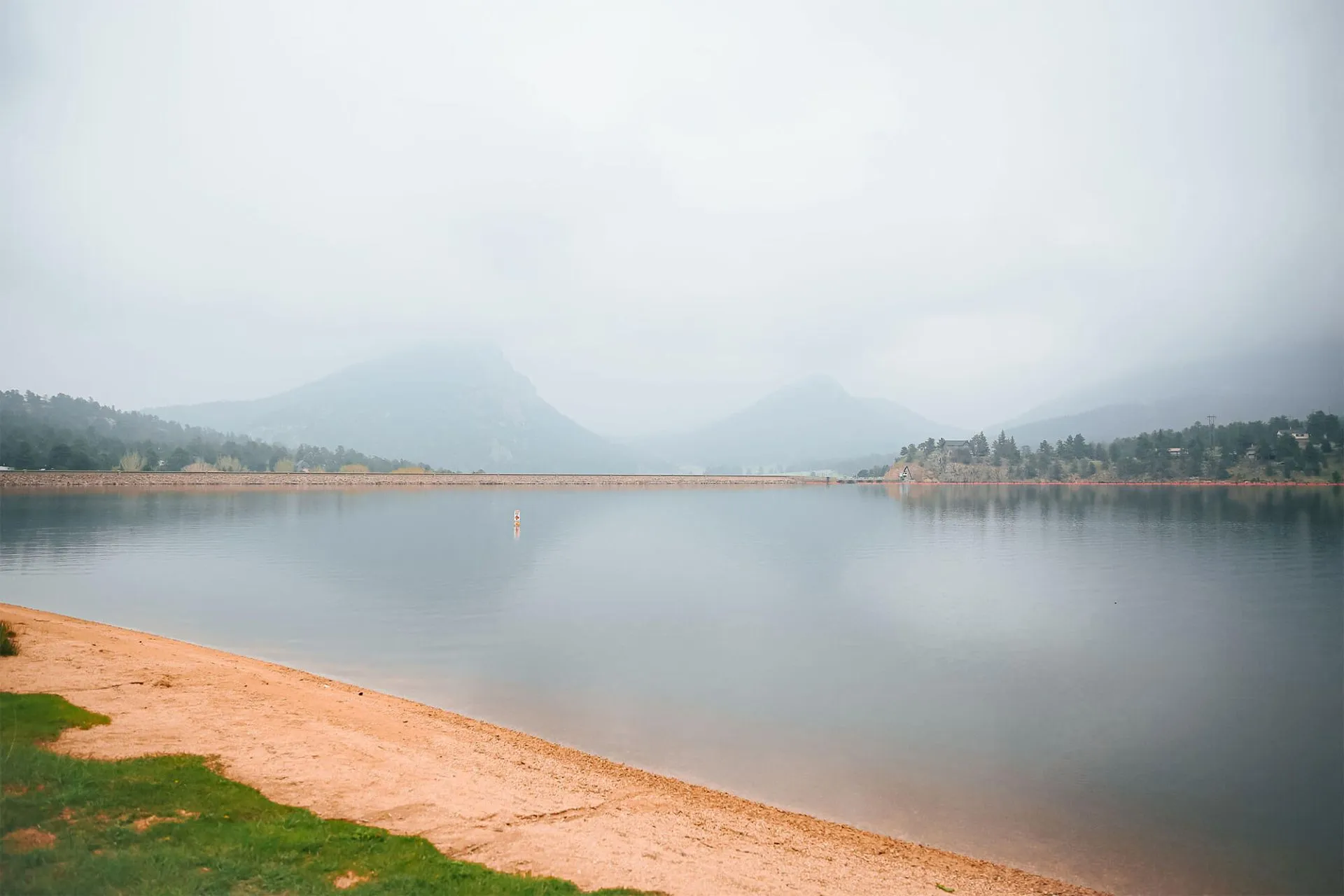 Hazy view over Lake Estes and surrounding mountains in Estes Park, Colorado