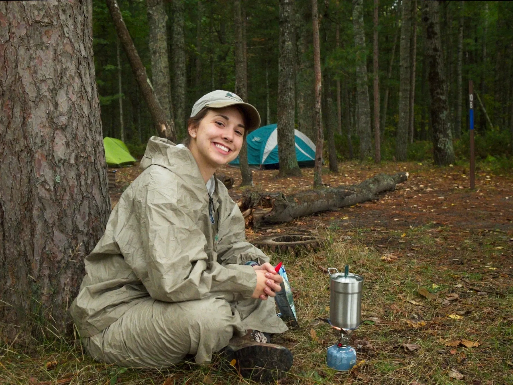 Hiker heating water for a meal at a campsite