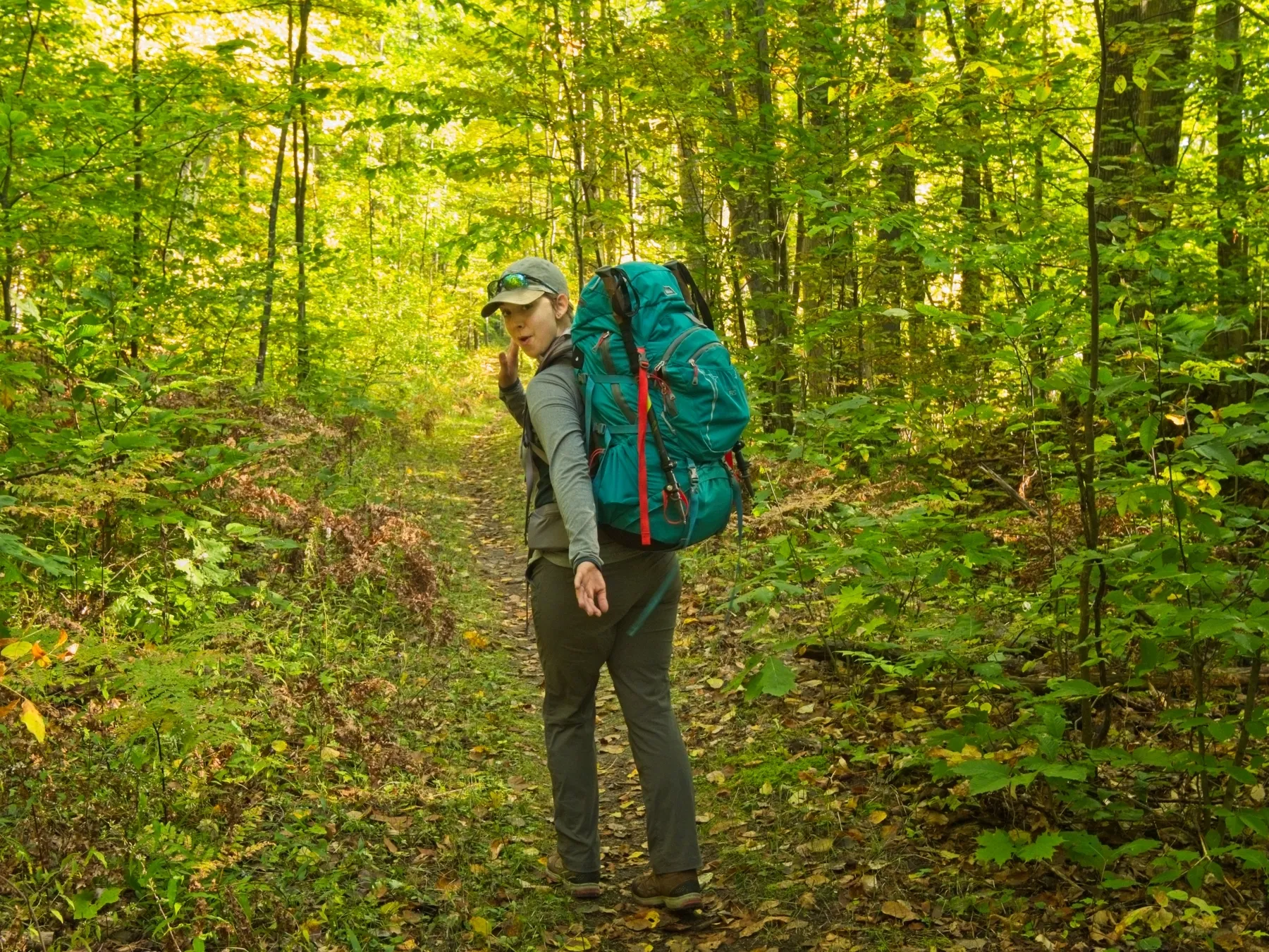 Hiker walking on an old railroad grade trail