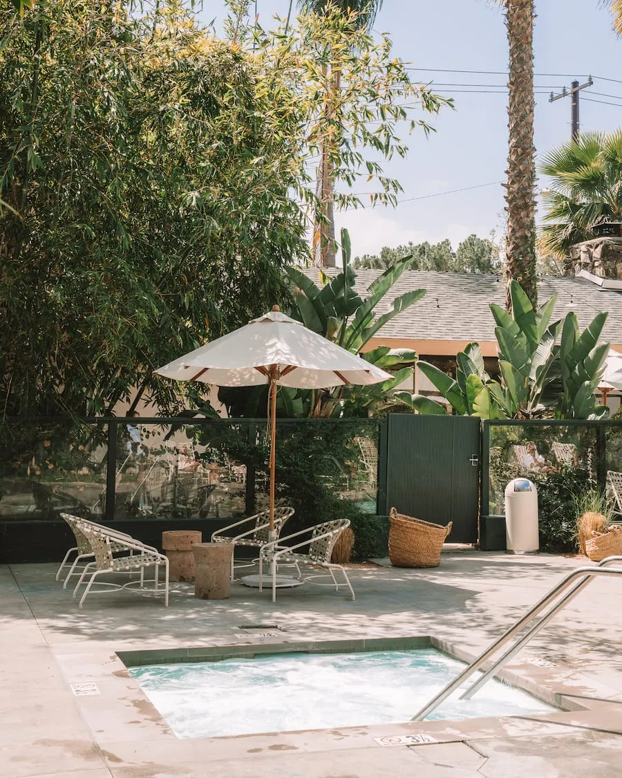 Hot tub area at Capri Hotel in Ojai surrounded by greenery