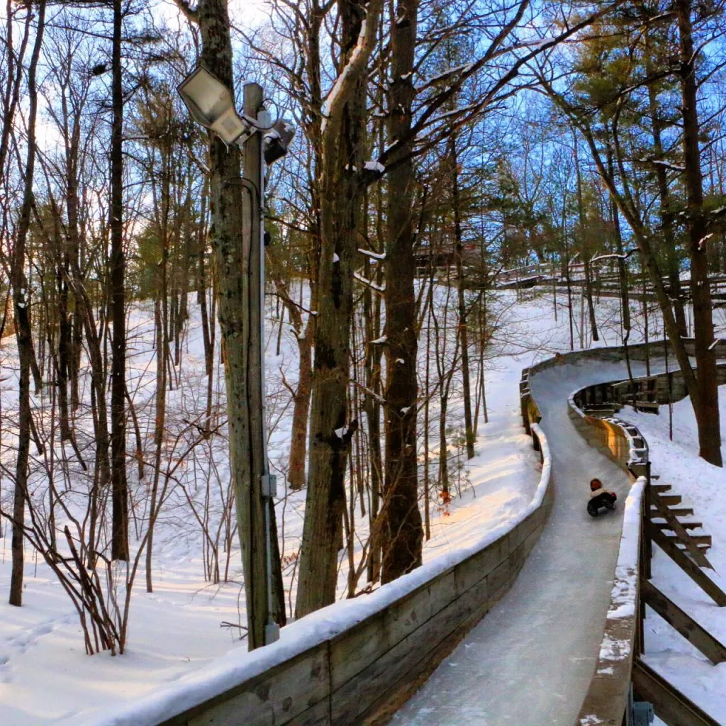 Ice skater on a wooded trail at Muskegon Winter Sports Complex, a unique Michigan winter activity