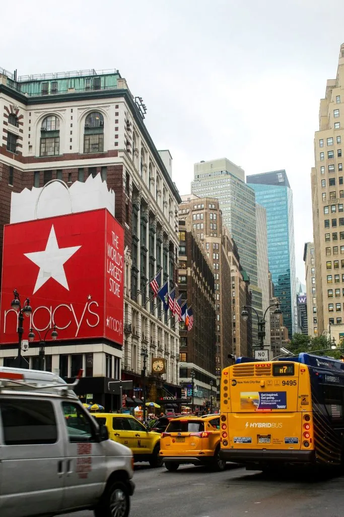 Iconic Macy's department store building with a bustling street scene in Herald Square NYC