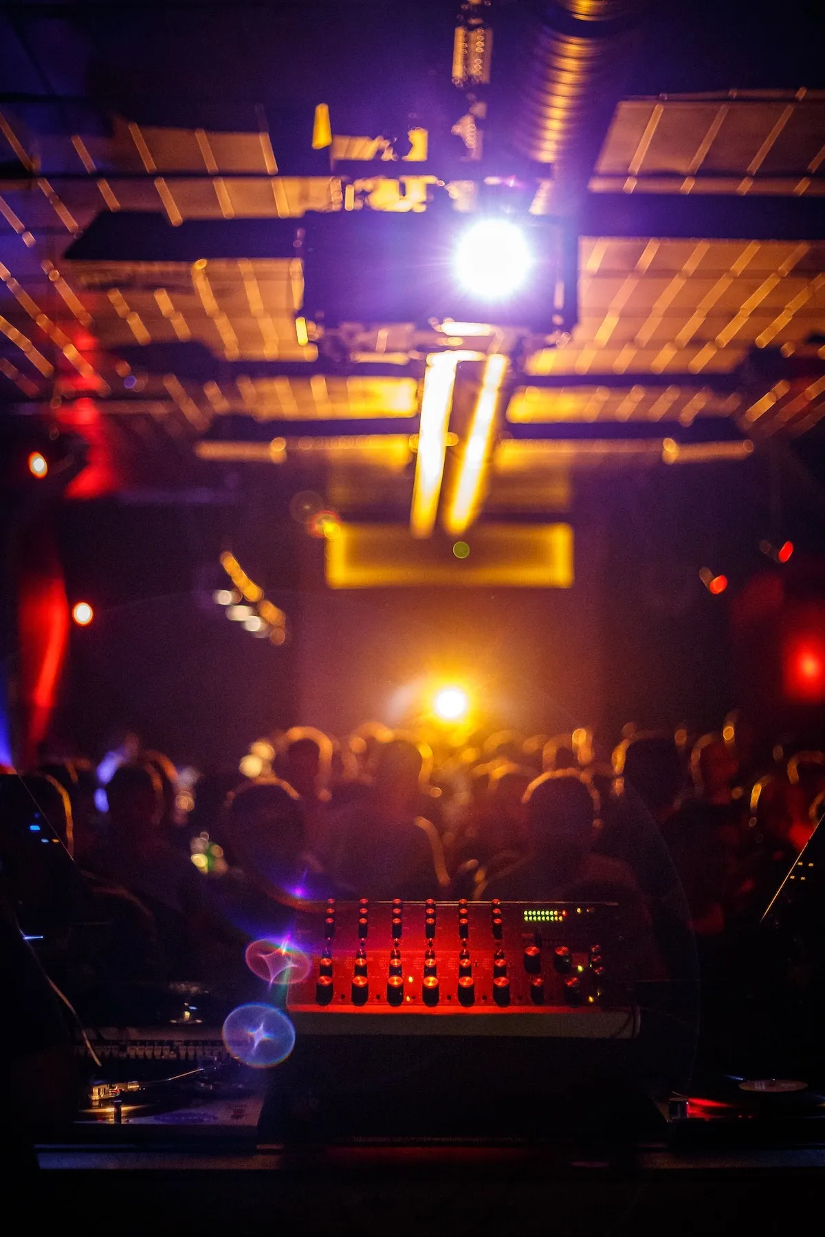 Inside a busy New York City nightclub with a DJ, capturing the energy of going out in new york.