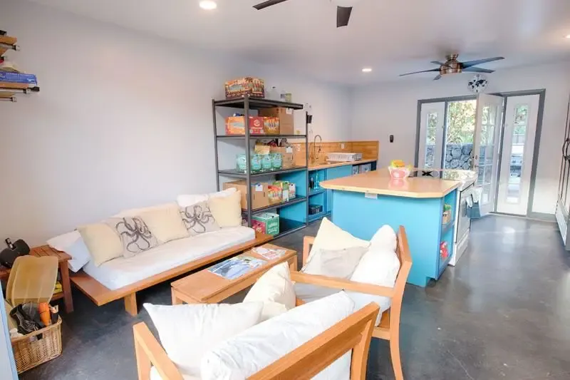 Interior common area of My Hawaii Hostel in Kailua-Kona, showing bright accents and comfortable seating.