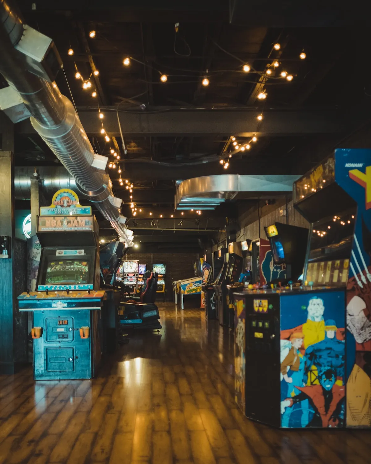Interior of a retro arcade in New York City with colorful games, a fun option for going out in new york.