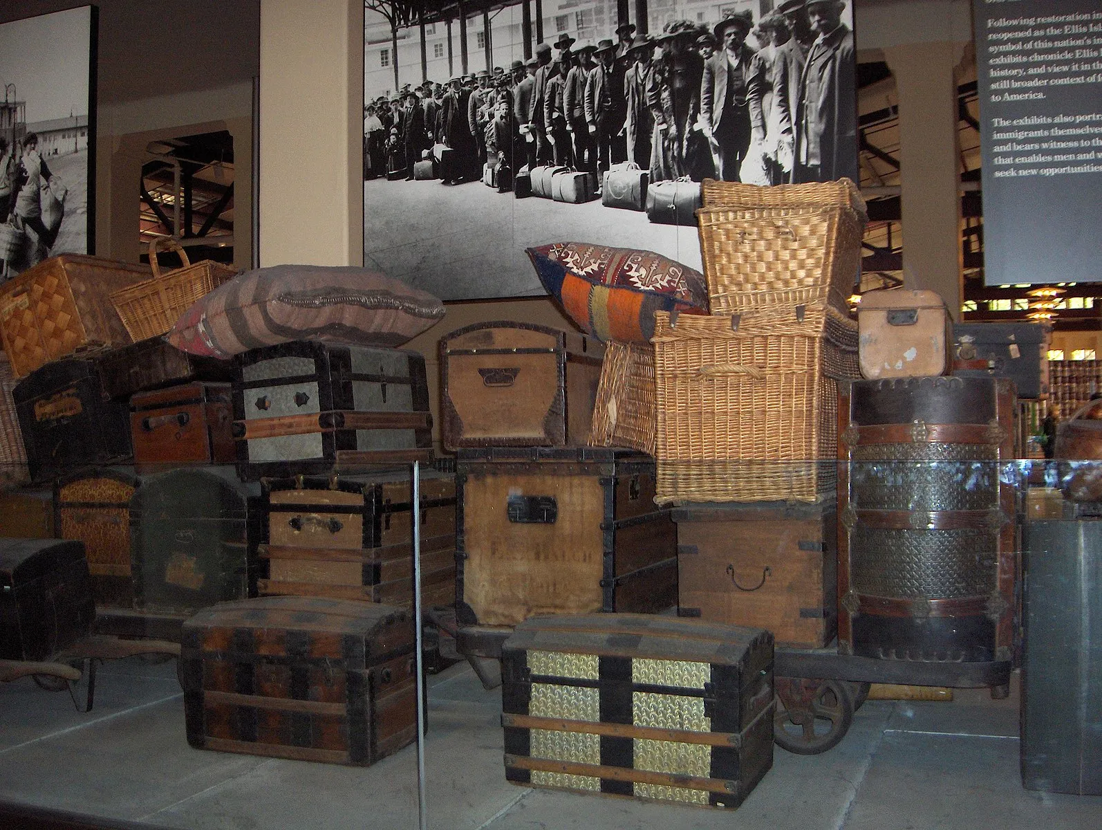 Interior view of the Baggage Room exhibit on Ellis Island, showing piles of vintage luggage
