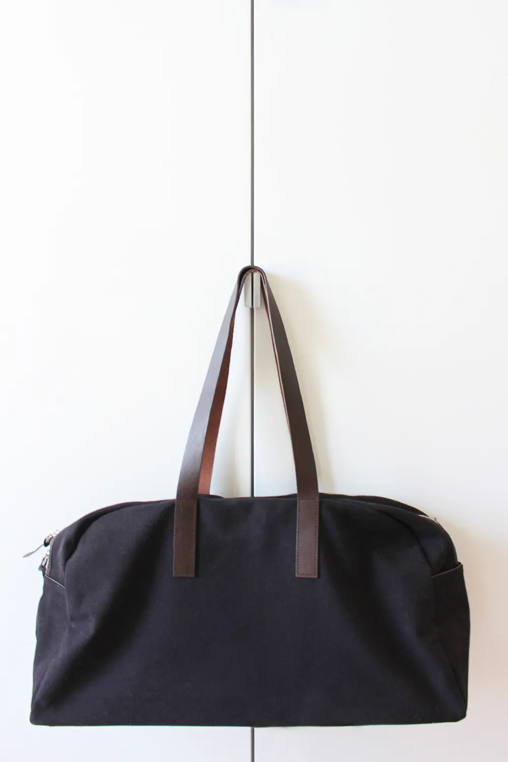 Items laid out before packing for a 9 day trip into a carry-on weekender bag