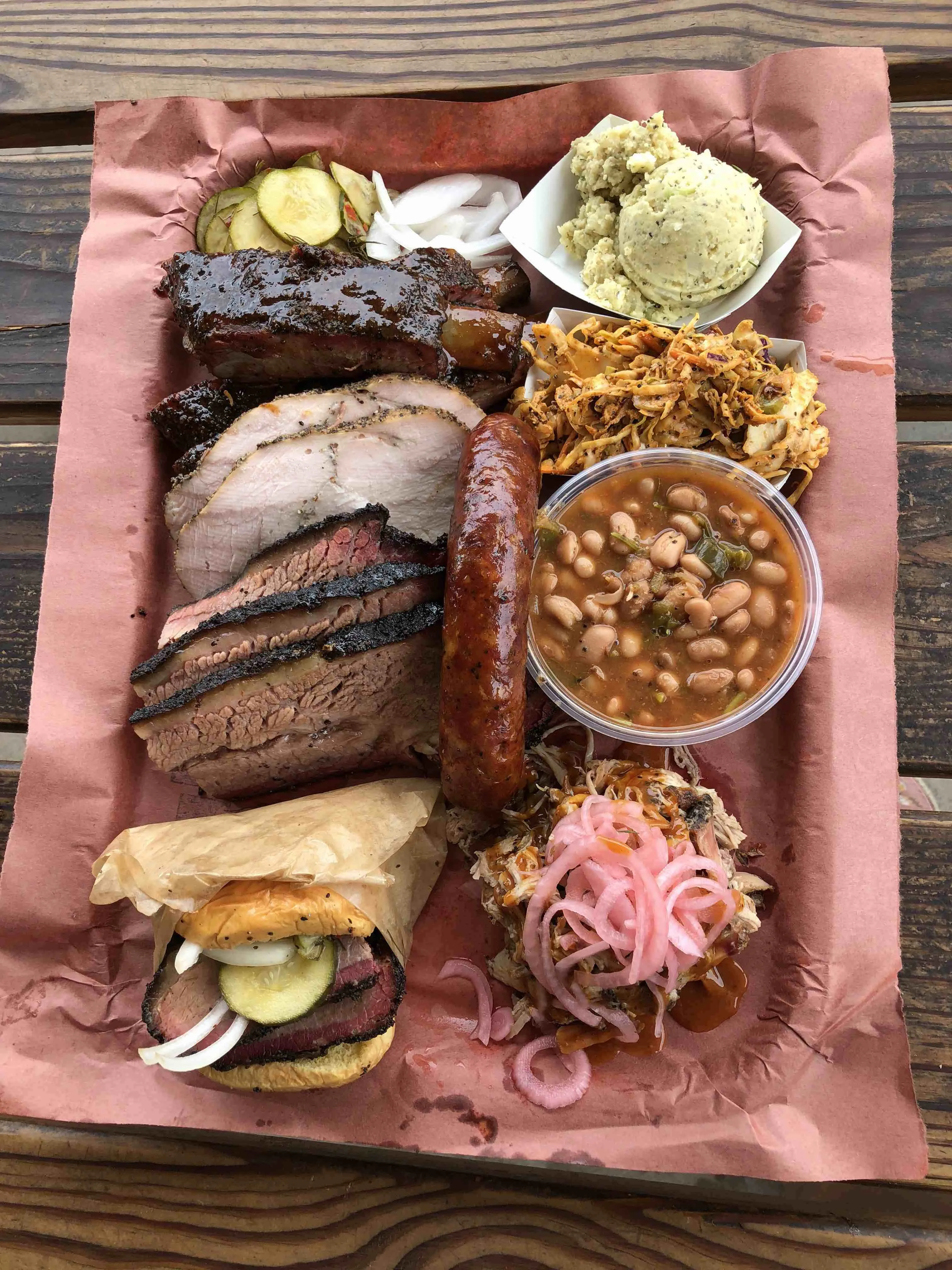 Juicy smoked brisket sandwich and pickles from LA Barbecue in Austin