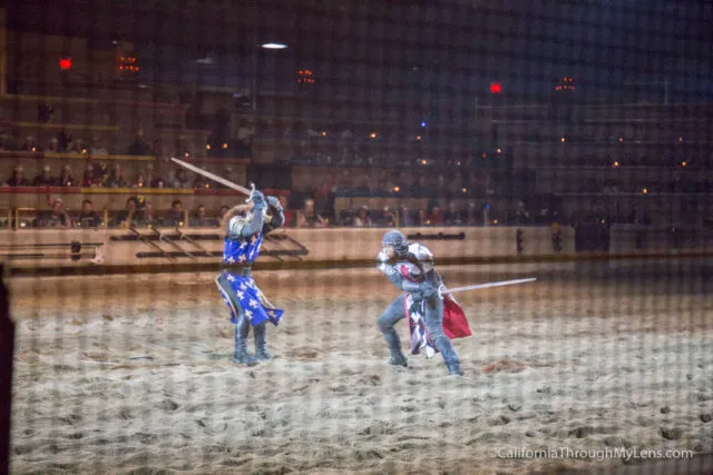 Knights on horseback jousting in an arena