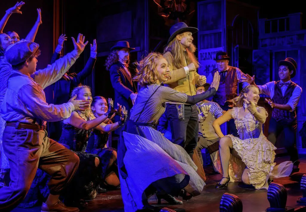 Large group of performers on stage at the Wild West Spectacular show in Cody - Entertainment Things To See And Do In Wyoming