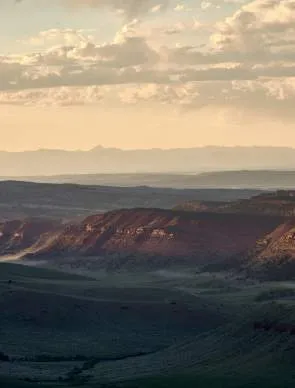 Large sweeping landscape with prairie and red dirt in a Wyoming region.