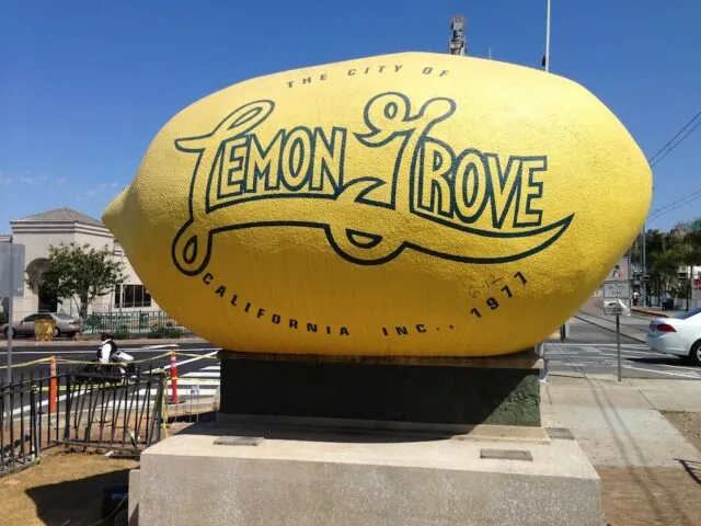Large, yellow lemon sculpture on a stand