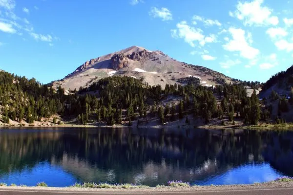Lassen Peak volcano rises above Lake Helen in Lassen Volcanic National Park