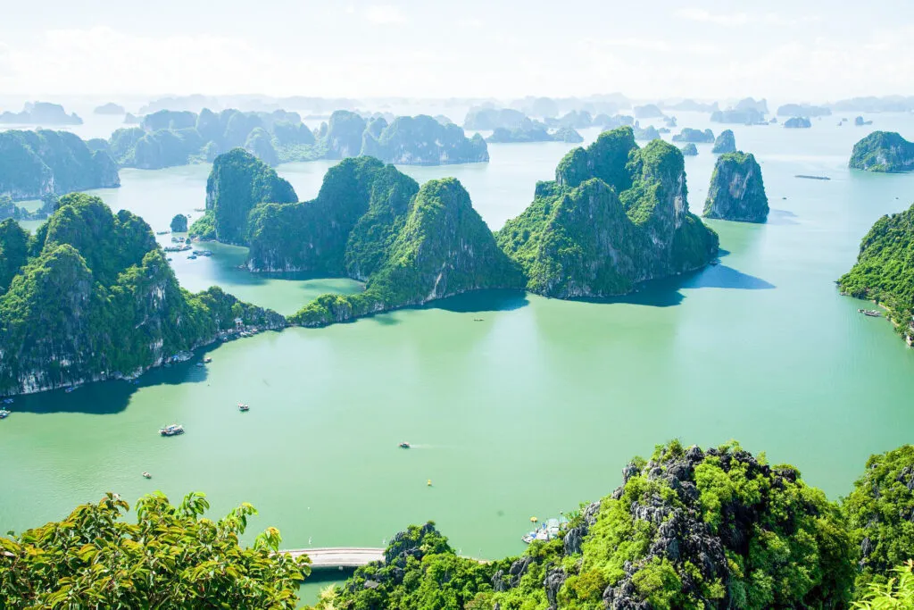 Limestone karsts rising dramatically from the calm, turquoise waters of Ha Long Bay