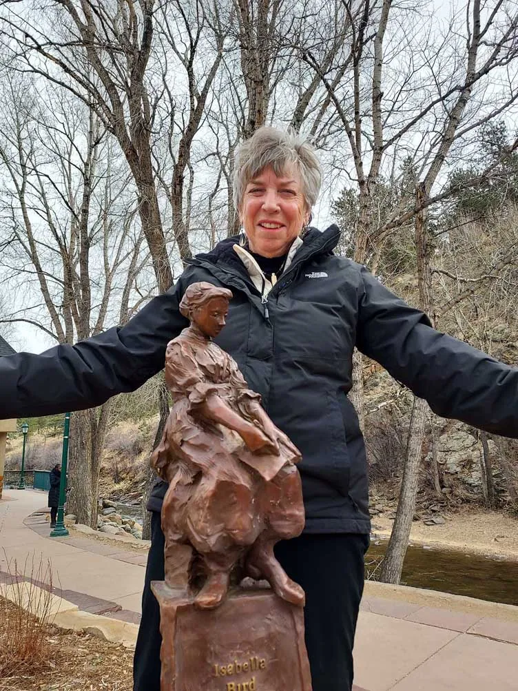 linda ballou with isabella bird statue in estes park