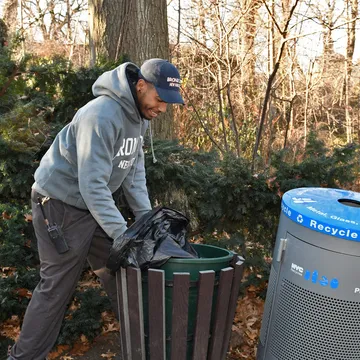 Maintenance worker attending to grounds at the Bronx Zoo, highlighting essential upkeep roles available for Bronx night jobs.