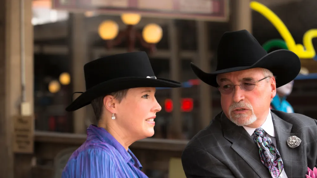 Man and woman in smart Western attire in Houston, reflecting the city's urban cowboy style