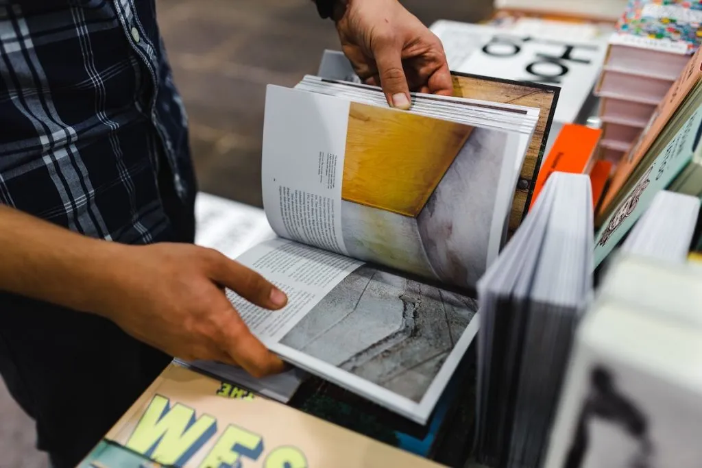 Man browsing books in a large, well-stocked bookstore in New York City