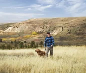 Man with dog enjoying an outdoor view in Wyoming