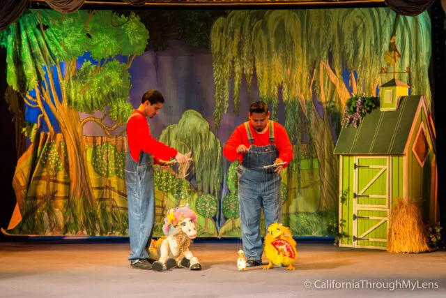 Marionette puppets performing on a stage in a theater