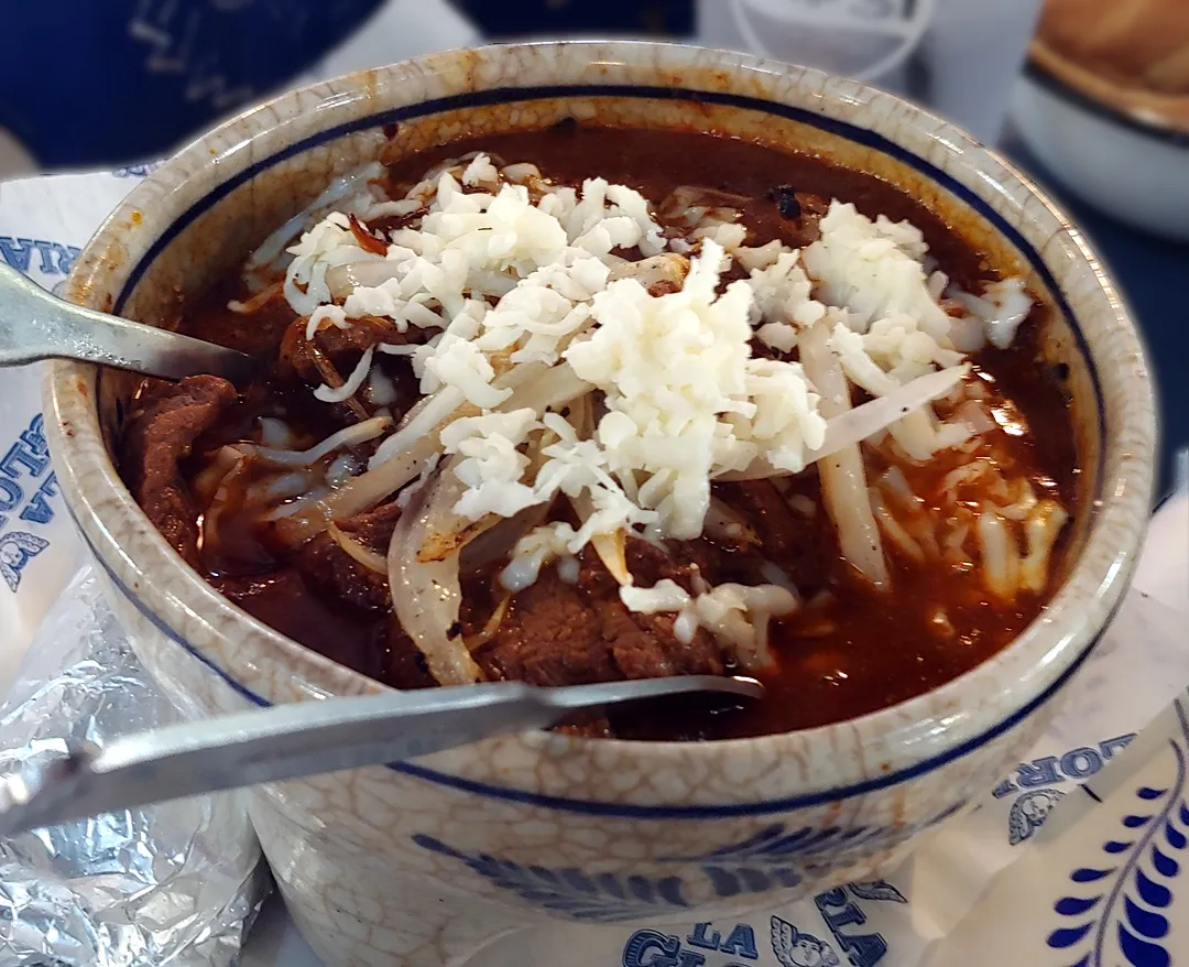 Molcajete dish with beef strips in sauce, served in a stone bowl