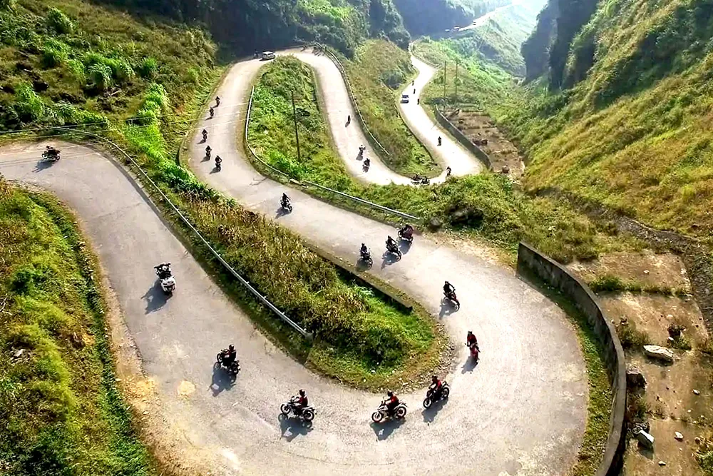 Motorbike riders explore the dramatic landscapes of the Ha Giang Loop, an epic Vietnam adventure