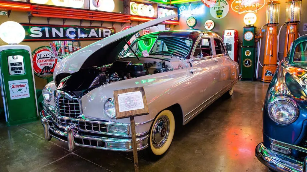 Old car, gas pumps, and neon signs at the Frontier Auto Museum in Gillette - Retro Things To See And Do In Wyoming
