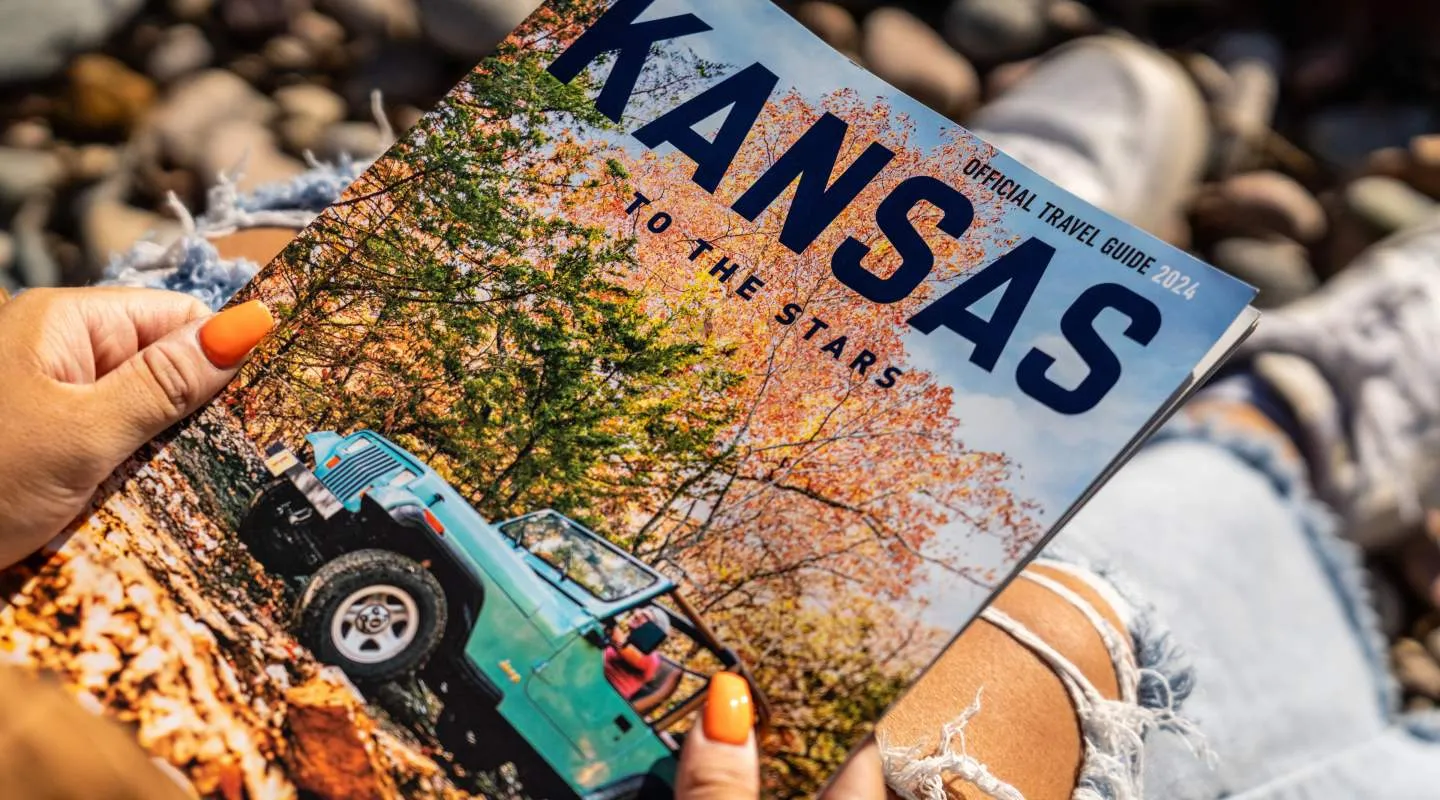 Open road stretching across a Kansas prairie, illustrating destinations in the free state travel guide
