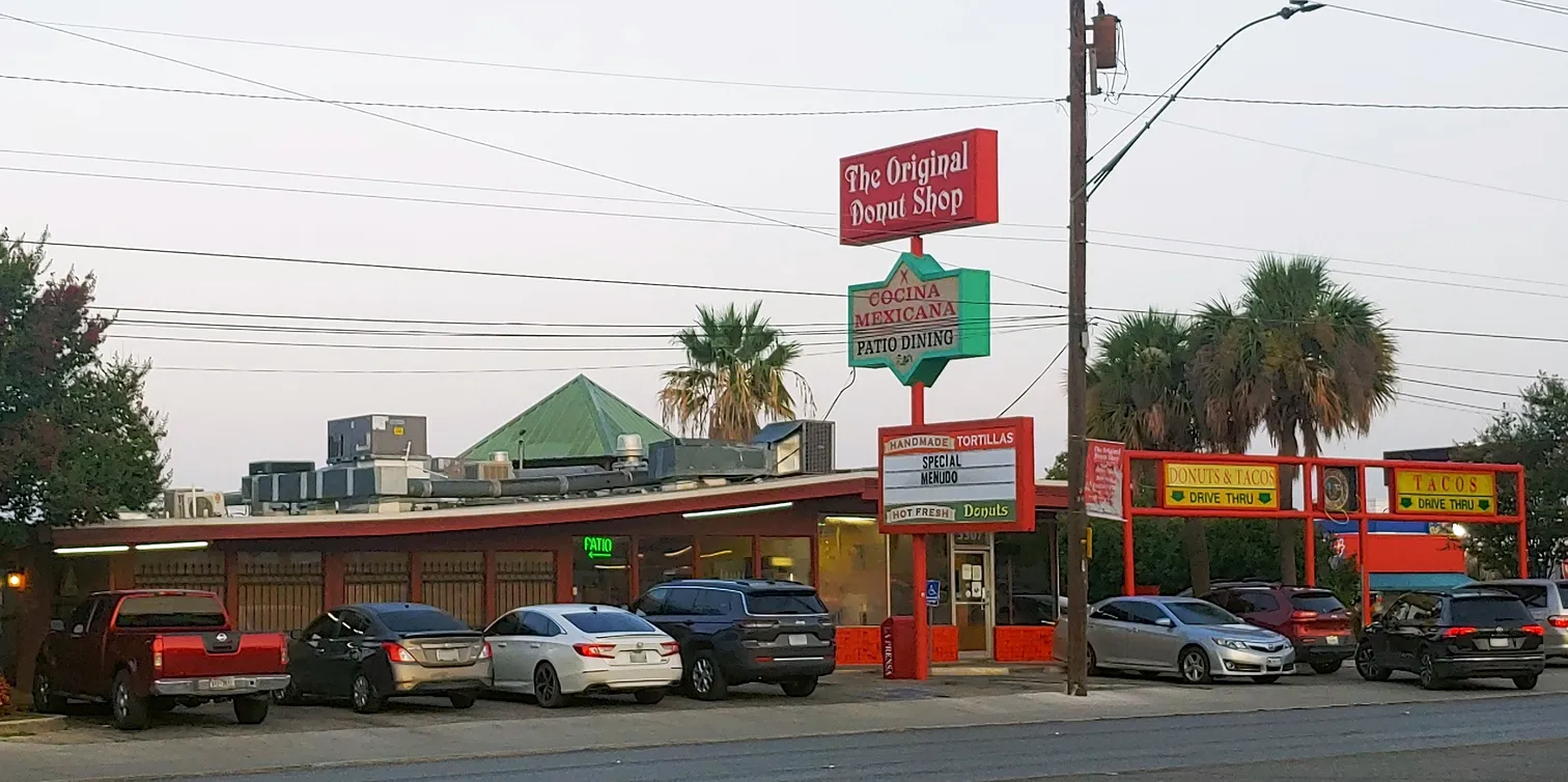 Original Donut Shop exterior sign, advertising both tacos and donuts, a unique combination for what to eat in san antonio texas