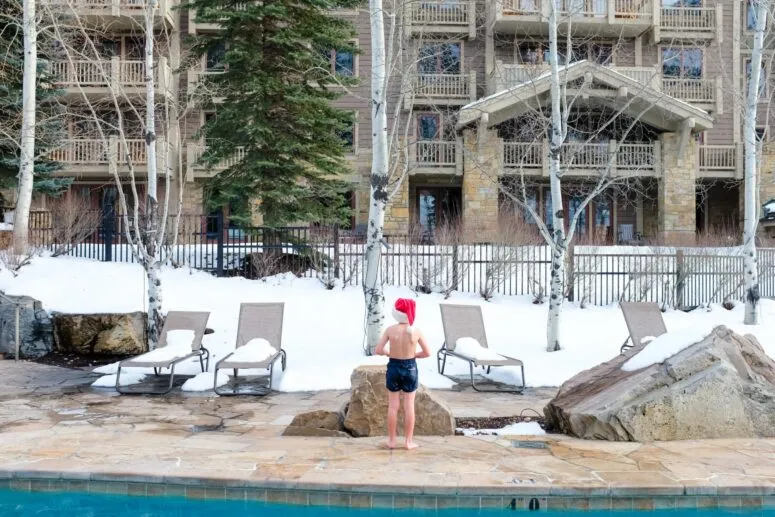 Outdoor pool with steam rising in a snowy setting at a Jackson Hole resort
